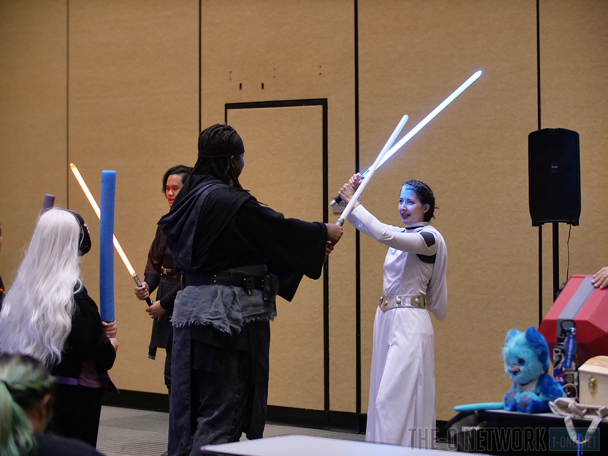 Attendees at lightsaber training in the Family Zone